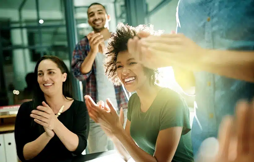 Qualfon employees clapping during company event