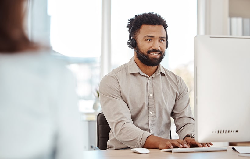 Smiling professional woman working on laptop