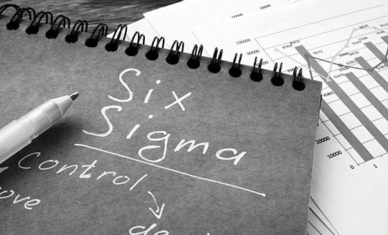 Six sigma sign as Lean Manufacturing concept. Notebook and papers.
