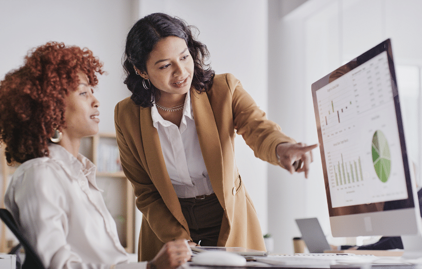 Business leaders collaborating on AI implementation strategy while reviewing data analytics