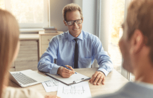 Business professional meeting with clients to discuss solutions and services