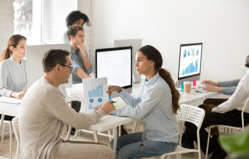 Learning and development team collaborating on AI-powered training strategy and performance analytics