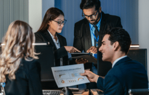 Business professionals reviewing data reports and analytics in a modern office environment.