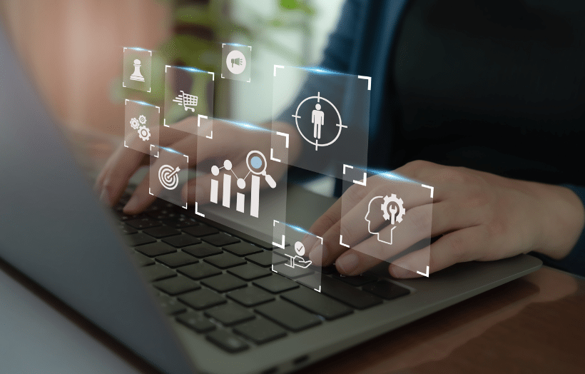 Person using laptop with data analytics and targeting icons overlay
