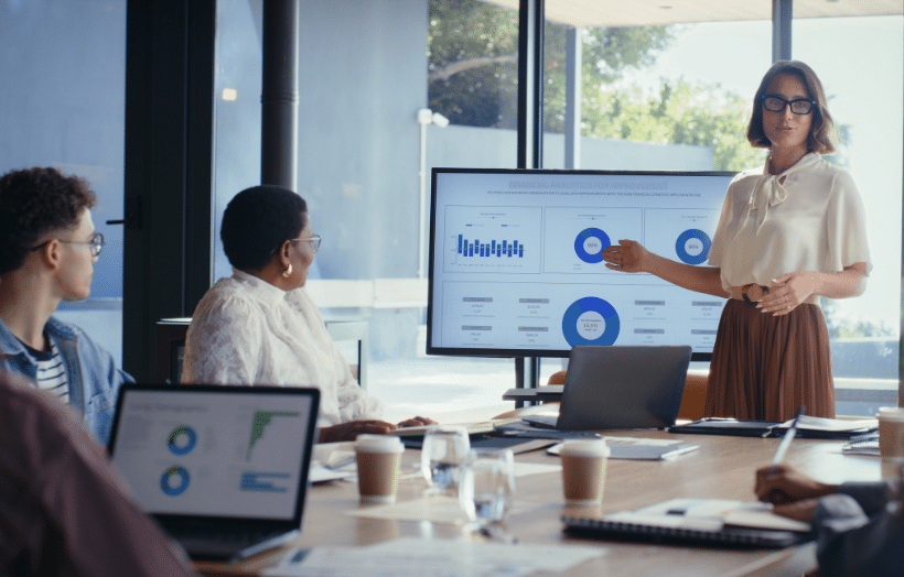 Business team reviews analytics presentation in modern conference room