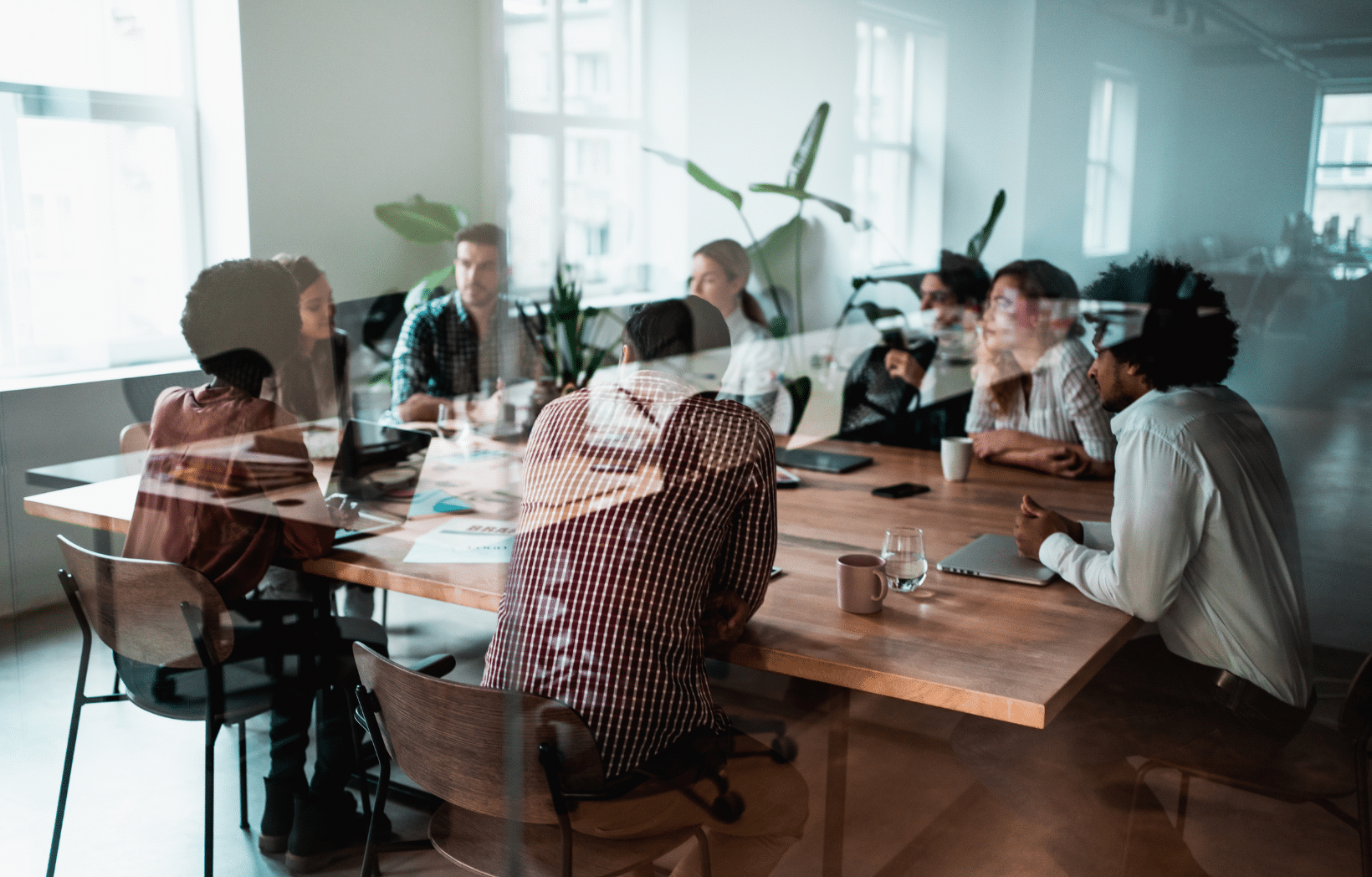 Business team collaborates around a conference table during a training planning meeting