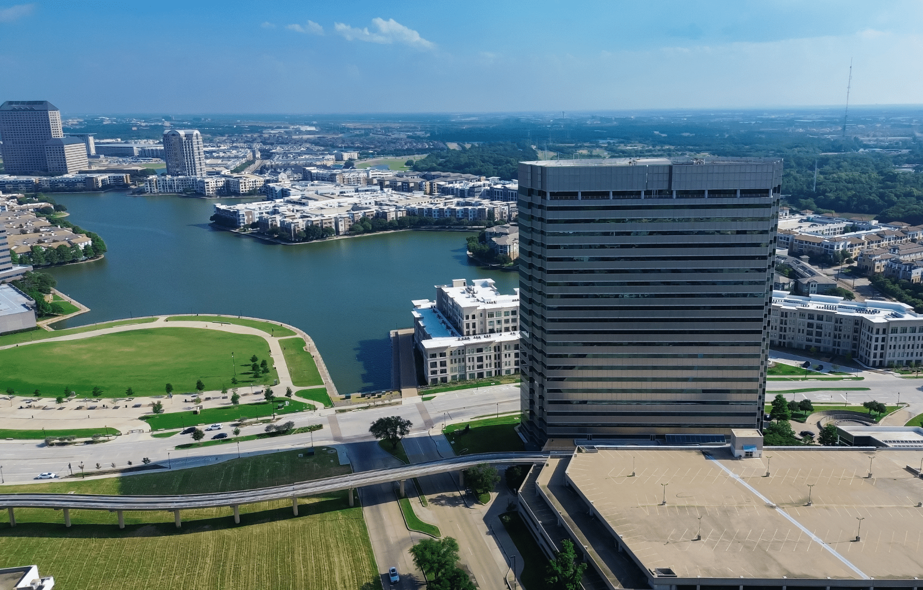 Aerial view of an office tower and lake in Irving, Texas