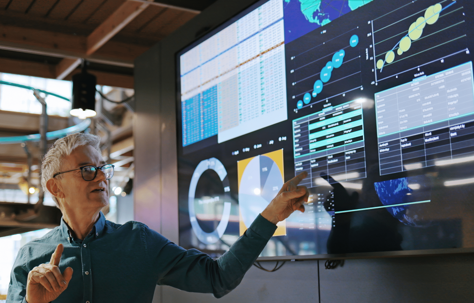 Business leader presenting a large analytics dashboard, illustrating human oversight within an AI governance framework
